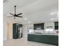 Modern kitchen featuring dark green cabinetry, a center island, stainless appliances, and lots of natural light at 99 Eastridge Dr, Eustis, FL 32726