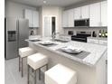Modern kitchen with a large island, stainless steel appliances, and white cabinetry at 1118 Cumberland Trail Dr, Lake Hamilton, FL 33851