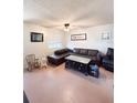 Cozy living room features a large leather sectional, neutral walls, and comfortable seating arrangement at 1150 Jackson St, Oviedo, FL 32765