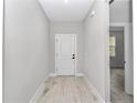 Hallway view featuring wood-look floors, neutral paint, and access to other rooms at 12197 Sw 76 Ln, Dunnellon, FL 34432