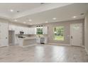 Spacious kitchen with white cabinetry, stainless appliances, and a large center island at 12460 Sw 48 Lane Rd, Ocala, FL 34481