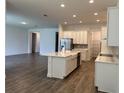 Open concept kitchen features an island, stainless steel appliances, and plenty of cabinet space at 15161 Lake Bessie Loop, Winter Garden, FL 34787