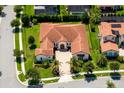 Expansive aerial view of a stunning home with lush landscaping and a brick driveway at 15698 Panther Lake Dr, Winter Garden, FL 34787