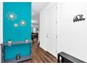 Bright entryway showcasing wood floors, modern decor, and stylish accents on a colorful wall at 1615 Sanibel Dr, Davenport, FL 33896