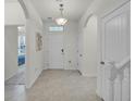 Bright foyer features tile flooring, arched doorways, and a stylish light fixture at 16484 Angel Fish Rd, Winter Garden, FL 34787