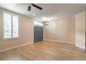 Bright living room with wood floors, gray doors, a ceiling fan and natural light at 1676 Song Sparrow Ct, Sanford, FL 32773