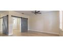 Bright living room with wood floors, gray doors, a ceiling fan and natural light at 1676 Song Sparrow Ct, Sanford, FL 32773