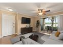 Cozy living room with a ceiling fan, sliding glass doors, a TV, and stylish furnishings at 1979 Summer Club Dr # 115, Oviedo, FL 32765