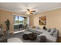 Bright living room with balcony access, neutral paint, and contemporary furniture at 1979 Summer Club Dr # 115, Oviedo, FL 32765
