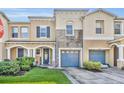 Charming townhome featuring stone accents, a well-manicured lawn, and a delightful garden area at 2039 Beachberry Ln, Oviedo, FL 32765
