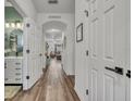 Inviting hallway with wood-look floors leading to bathroom and living area at 2039 Beachberry Ln, Oviedo, FL 32765