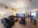 Spacious living room featuring tile flooring, a large decorative ledge, and comfortable seating at 212 Ashford Dr, Davenport, FL 33837