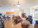 Bright and airy living room with tile floors, comfortable furniture, and an open layout at 212 Ashford Dr, Davenport, FL 33837