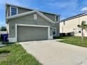 Two-story home with a two-car garage and adjacent units in a residential neighborhood at 235 Hibiscus St, Winter Haven, FL 33881