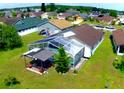 Aerial view of a spacious backyard with a screened-in pool and covered patio area for outdoor relaxation at 2376 Flamingo Lakes Dr, Kissimmee, FL 34743