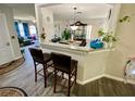 Open concept kitchen and living area with granite counters, breakfast bar, and updated flooring at 2376 Flamingo Lakes Dr, Kissimmee, FL 34743