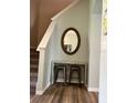 Inviting entryway featuring a decorative table, stools, mirror and staircase at 2706 Camaro Dr, Kissimmee, FL 34746