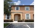 Charming two-story condo with tan exterior, white trim, and covered front porch at 2706 Camaro Dr, Kissimmee, FL 34746
