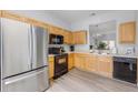 Bright kitchen showcasing wood cabinets, stainless steel appliances and modern flooring at 2706 Camaro Dr, Kissimmee, FL 34746