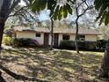 Inviting single story home featuring a brick accent wall and well-maintained landscaping at 285 W 2Nd St, Chuluota, FL 32766