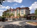 Exterior front view of Galleria Palms Hotel featuring attractive landscaping and well-maintained facade at 3000 Maingate Ln # 210, Kissimmee, FL 34747
