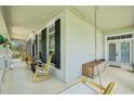 Relaxing outdoor porch with rocking chairs, swing, and views of the manicured landscape at 3201 Glenmere Way, Orlando, FL 32828