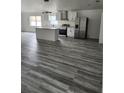 Open-concept kitchen featuring stainless steel appliances and a center island at 3446 Cypress Point Cir, St Cloud, FL 34772