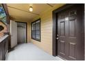Private porch features closet, neutral paint, and a lovely exterior door with address numbers displayed at 380 Lake Ontario Ct # 201, Altamonte Springs, FL 32701