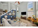 Stylish living room with vaulted ceiling, tall windows, and contemporary furnishings at 383 Remington Dr, Oviedo, FL 32765
