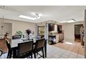 Eat-in kitchen features tile floor, dark cabinetry and sliding doors to the patio at 513 Dew Drop Cv, Casselberry, FL 32707