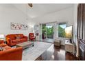 Stylish living room boasting dark wood floors, vaulted ceiling, and natural light streaming through sliding glass doors at 6057 Lake Pointe Dr # 408, Orlando, FL 32822