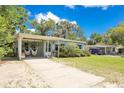 Lovely single-story home featuring a covered parking area and well-maintained landscaping at 633 E Church Ave, Longwood, FL 32750