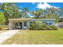 Charming single-story home with a covered parking area and well-maintained landscaping at 633 E Church Ave, Longwood, FL 32750