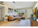 Inviting living room with neutral walls, a comfortable sofa, and a bright window at 633 E Church Ave, Longwood, FL 32750