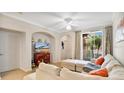 Comfortable living room with neutral tones, a ceiling fan, and sliding glass doors to a screened patio at 12220 Wild Iris Way # 103, Orlando, FL 32837