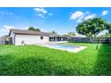 Well-manicured backyard featuring an in-ground pool, and ample green space at 123 Tuxpan Ln, Kissimmee, FL 34743