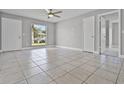 Spacious living room with tile flooring, abundant natural light, and neutral paint at 123 Tuxpan Ln, Kissimmee, FL 34743