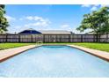 Sparkling pool with clean lines and ample space for backyard relaxation at 123 Tuxpan Ln, Kissimmee, FL 34743