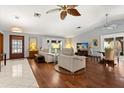 Spacious living room featuring hardwood floors, bright windows, and designer ceiling fans at 1247 Rosemary Dr, Orlando, FL 32807