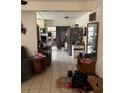 Open-concept living space with tile floors seamlessly connecting living area and kitchen at 128 N Sunland Dr, Sanford, FL 32773