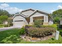 Well-maintained home featuring a lush landscaped front yard and a brick-paved driveway at 1386 Longley Pl, Deland, FL 32724