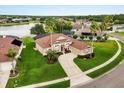 Beautiful aerial view of property with lush greenery, a lake nearby, and a well-maintained lawn at 14174 Islamorada Dr, Orlando, FL 32837