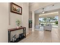 Inviting foyer featuring neutral walls, tile flooring, console table, and seamless flow into the living area at 14174 Islamorada Dr, Orlando, FL 32837