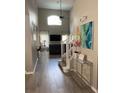 Bright entryway featuring high ceilings, hardwood floors, modern decor, and open access to the living room at 1428 Casterton Cir, Davenport, FL 33897