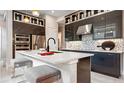 Stylish kitchen with an island, stainless steel appliances, and unique backsplash at 1461 Santorini Way, Tavares, FL 32778