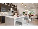 Modern kitchen with sleek cabinets, a white quartz island, and stainless steel appliances at 1461 Santorini Way, Tavares, FL 32778