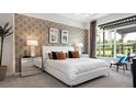 Cozy main bedroom with large windows offering abundant natural light and stylish decor at 1461 Santorini Way, Tavares, FL 32778
