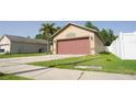 Well-maintained single-story home featuring a large two-car garage and a verdant front lawn at 16116 Corner Lake Dr, Orlando, FL 32820
