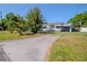 Inviting home featuring a long driveway and well-maintained lawn at 1615 Crestwood Dr, Orlando, FL 32804