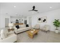 Bright, open living room with modern furnishings and an adjacent kitchen, creating an inviting space at 1773 Groveline Rd, St Cloud, FL 34771